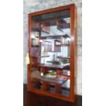 HANGING DISPLAY CABINET, Chinese with a glazed door, mirrored back and a multitude of shelves,