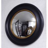 CIRCULAR CONVEX MIRROR, Regency style with a circular ebonised frame with reeded gilt border,