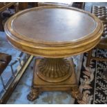 CENTRE TABLE, round inset leather top on reeded column on quadraform base with winged paw feet,