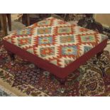 HEARTH STOOL, kilim and red leather upholstered, 75cm W x 71cm D.