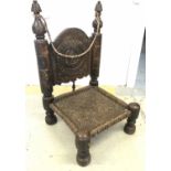 LOW CHAIR, Indian 17th century style with carved back and woven seat, 92cm H x 54cm x 55cm.