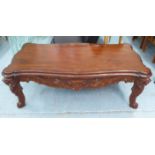 LOW TABLE, mahogany with a shaped top and a leaf decorated apron on lion head supports,