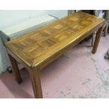TABLE, the oak parquetry top with a brass trim, 50cm D x 133cm L x 68cm H.