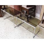 NEST OF TABLES, 1970's style chrome and smoked glass, largest 62cm x 33cm x 41cm H.