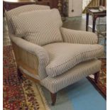 ARMCHAIR, early 20th century Howard style beechwood, partially upholstered in ticking material,