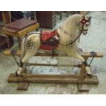 ROCKING HORSE, painted with leather saddle on an old pine and beech base, 97cm H x 126cm L x 40cm.
