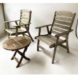GARDEN ARMCHAIRS, a pair, weathered teak of slatted form, 66cm W, together with a teak low table,