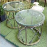 LAMP TABLES, a pair, having round glass tops on x framed bronzed cross arrow frames,