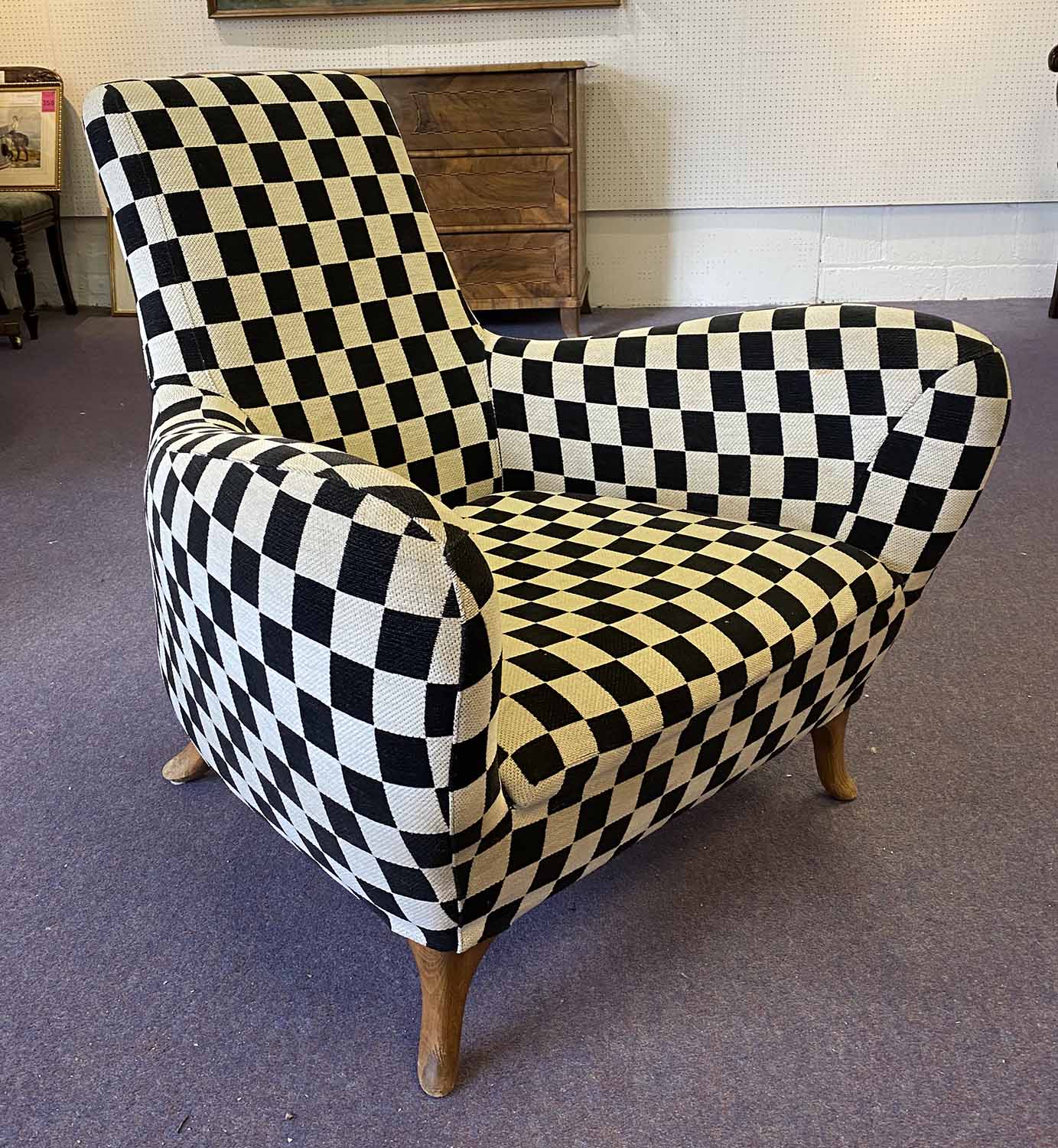 ARMCHAIR, circa 1960's Danish, black and white checkerboard upholstered on outswept legs,