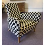 ARMCHAIR, circa 1960's Danish, black and white checkerboard upholstered on outswept legs,