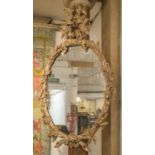 WALL MIRRORS, a pair, George III style carved wood with old oval plates, 115cm H x 71cm W.