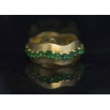 AN EIGHTEEN CARAT GOLD AND EMERALD BAND RING,