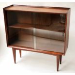 BOOKCASE, 1970's teak with glazed doors adjustable shelf and tapering supports,