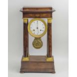 PORTICO CLOCK, Charles X mahogany and gilt bronze with enamelled dial and leaf cast pendulum,