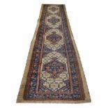 ANTIQUE SERAB RUNNER, 460cm x 117cm, rows of medallions within complimentary borders.