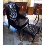 WING ARMCHAIR, Georgian style in buttoned black leather, 109cm H x 83cm W and a matching stool,