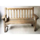 GARDEN BENCH, silvery weathered teak of slatted construction with broad flat top arms, 131cm W.