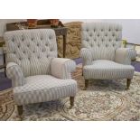 ARMCHAIRS, a pair, in ticking upholstery with buttoned backs, beech legs and brass castors, 88cm W.
