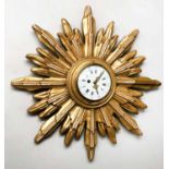 STARBURST CLOCK, late 19th/early 20th century French gilt wood with white enamel dial,