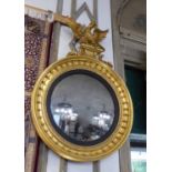 CONVEX MIRROR, Regency giltwood with eagle surmount, ball decoration and an inner ebonised slip,