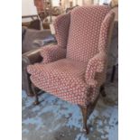 WINGBACK CHAIR, in a patterned red fabric on cabriole supports, 90cm x 118cm H.