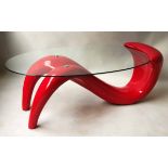 LOW TABLE, oval glass top on red perspex figural form support, 46cm H x 125cm W x 66cm D.