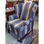 WING ARMCHAIR, upholstered in blue and gold fabric raised on square stretchered supports,