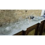 GLASSWARE, a pair of clear cut candlesticks 20cm H, a set of twelve side dishes,