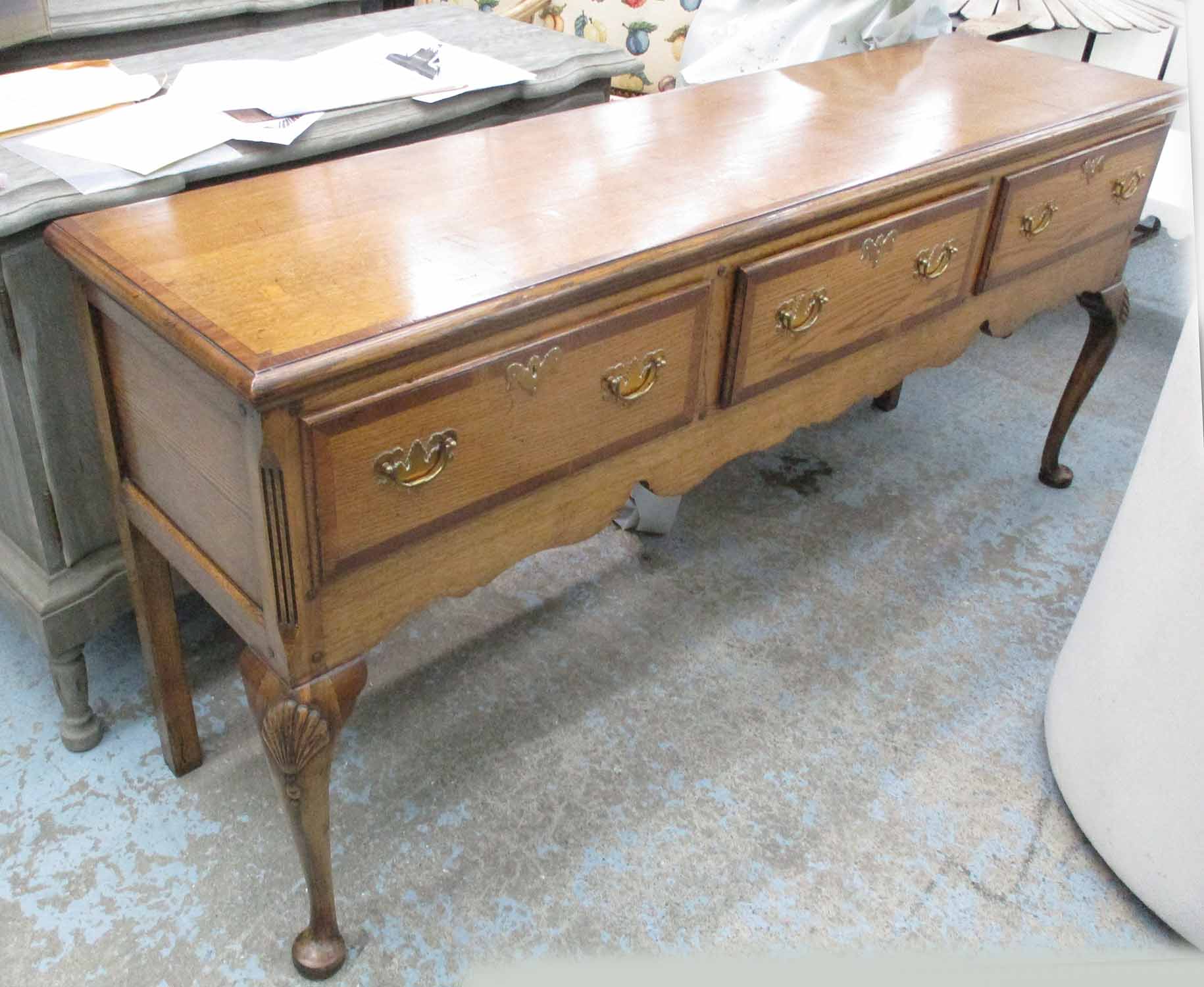 DRESSER BASE, oak with three drawers below on cabriole supports, 183cm x 47cm x 82cm H.