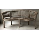 BANANA BENCH, silvering weathered teak of slatted form and bowed outline, 155cm W.