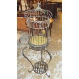 BIRDCAGE, metal on splayed supports with a trellis undertier, 145cm H.