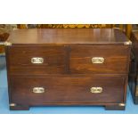 LOW CHEST, military style stained pine and brass with three drawers, 56cm H x 91cm W x 41cm D.