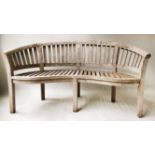 BANANA BENCH, silvering weathered teak of slatted form and bowed outline, 155cm W.