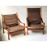 SAFARI ARMCHAIRS, a matching pair teak framed canvas strung and stitched leather brass screwed arms,