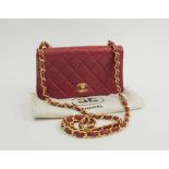 CHANEL MINI FLAP BAG, quilted red leather with gold tone hardware, matching leather lining,