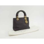 CHRISTIAN DIOR LADY DIOR, in quilt black fabric, gold tone hardware and Dior charmes,