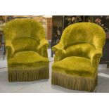 BERGERES, a pair, Napoleon III ebonised in tassled olive green chenille, 75cm W 82cmH x 80cmD.