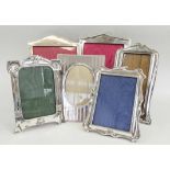 PHOTOGRAPH FRAMES, a collection of six, early 20th century silver, including Walker & Hall examples,