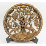 CARVINGS, a pair, giltwood and painted circular design with birds on fruiting branches, 45cm diam.