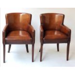 BRIDGE ARMCHAIRS, a pair, piped hand finished leaf brown leather with tapering supports.