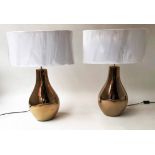 LAMPS, a pair, gilt vase shaped bases and white oval shades, 68cm H.