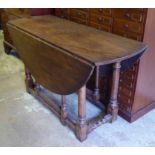 GATELEG TABLE, 20th century oak with drop flap top raised on turned stretchered supports,