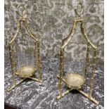 STORM LANTERNS, a pair, Hollywood Regency style, faux bamboo, gilt metal and glass.