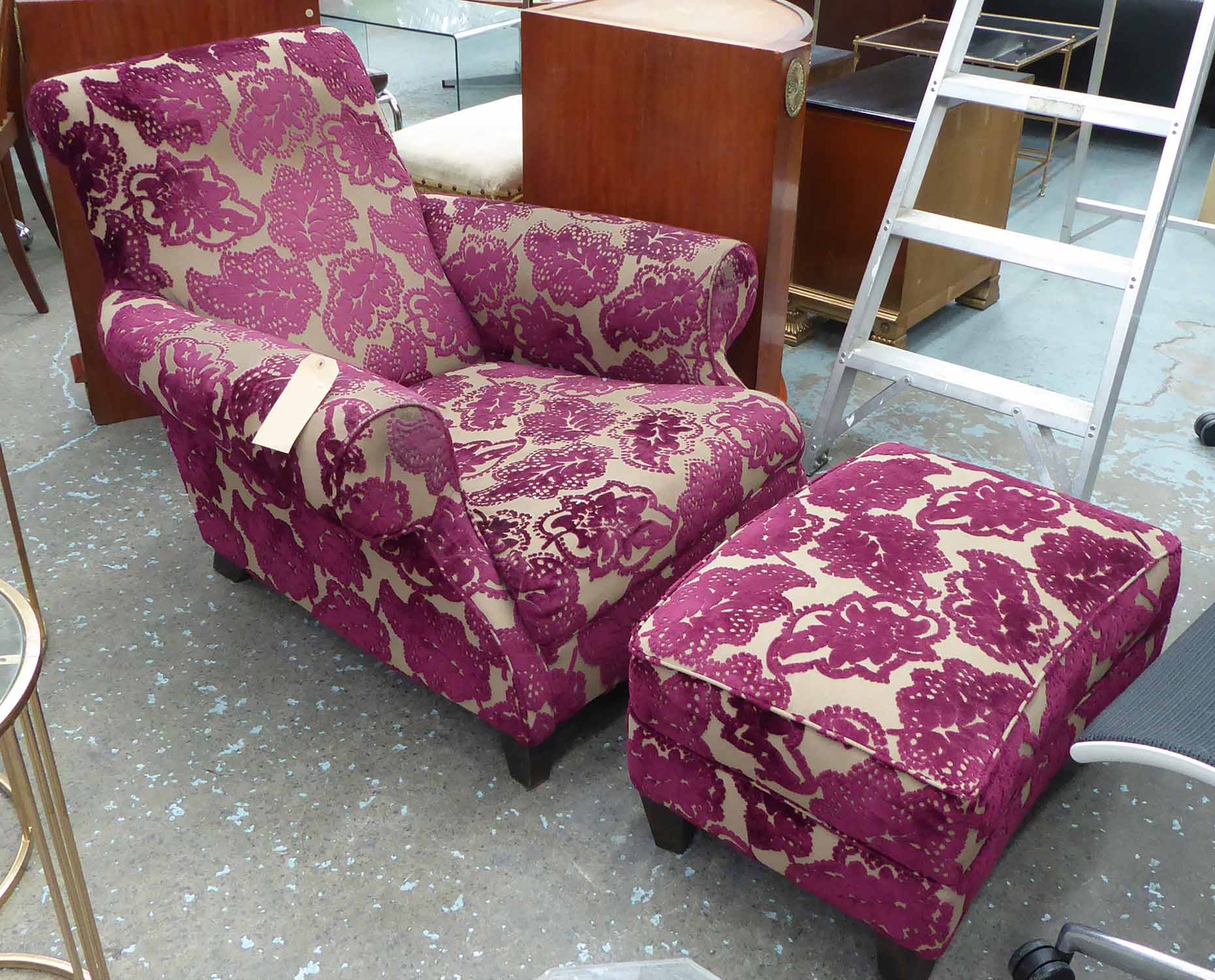 ATTRIBUTED TO HEALS ARMCHAIR AND FOOTSTOOL, purple foliate upholstery, 90cm H.