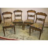 DINING CHAIRS, a set of four, George IV rosewood with needlework tapestry seats.