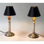 CANDLESTICK LAMPS, a pair, silvered metal, each with column ad base, 34cm H.