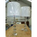 TABLE LAMPS, a pair, contemporary, lead crystal, with ivory shades, 85cm H.