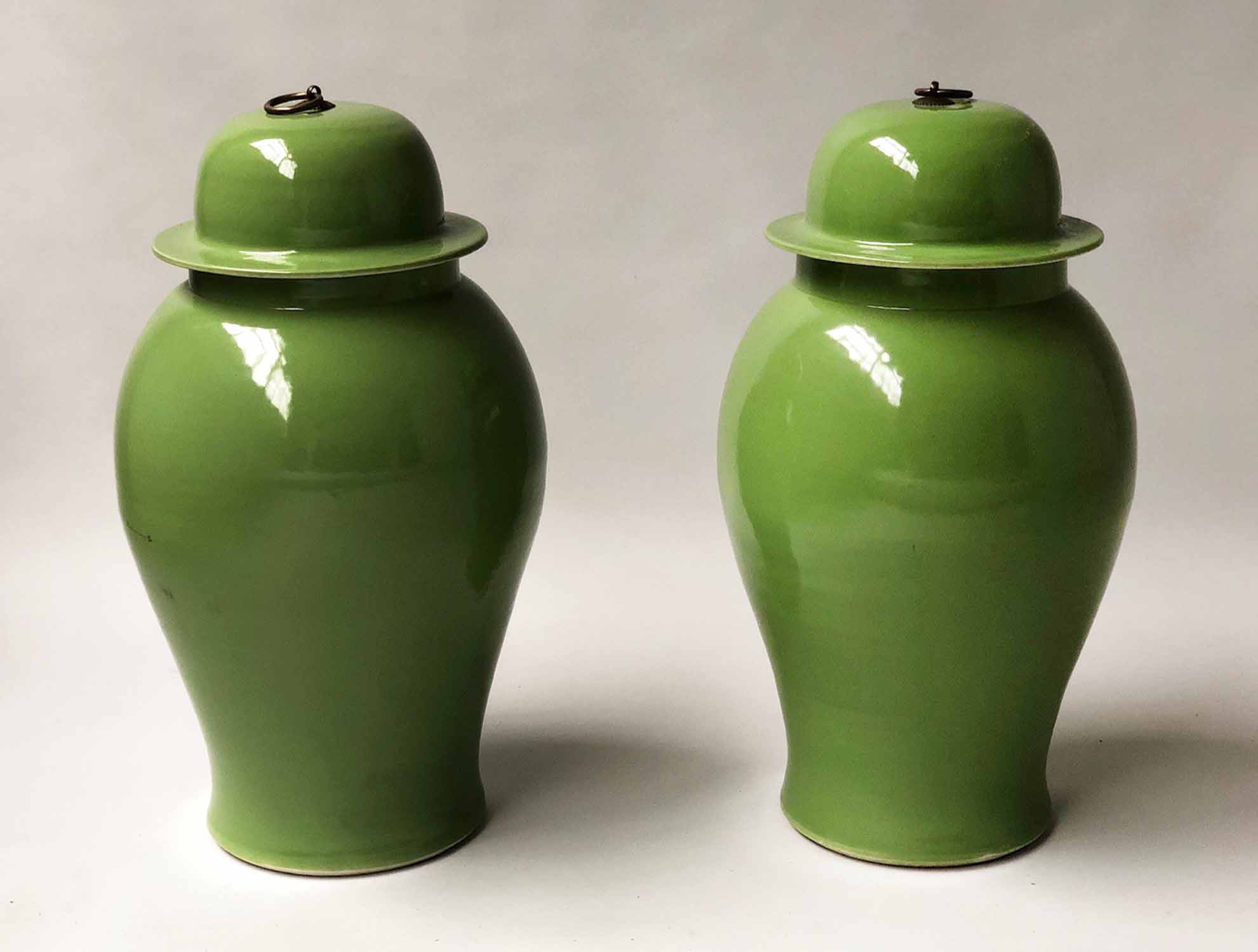 TEMPLE JARS, a pair, Chinese leaf green ceramic in the form of ginger jar with lids, 54cm H.