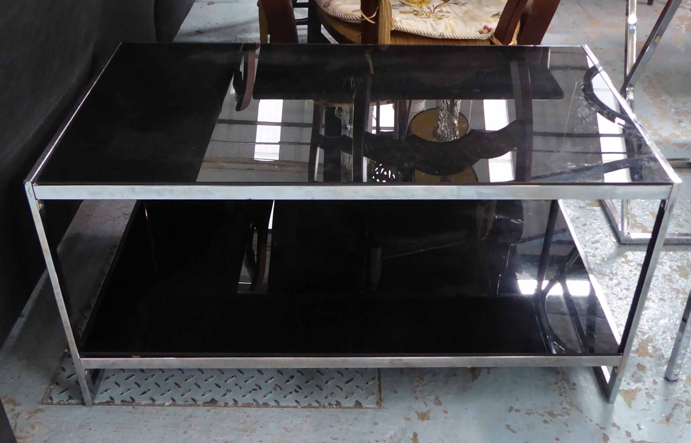 LOW TABLE, smoked glass top with undertier, on a polished metal base, 100cm L x 57cm D x 52cm H.