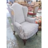 WINGBACK ARMCHAIR, newly upholstered in ticking on cabriole supports, 83cm x 112cm H.